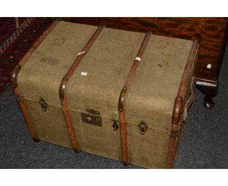 An early 20th century canvas and wooden bound travelling trunk