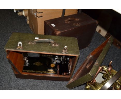 A manual Singer sewing machine, another , electric