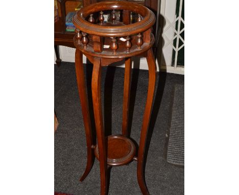 A reproduction mahogany jardiniere stand, circular gallery, bowed legs, shelf stretcher