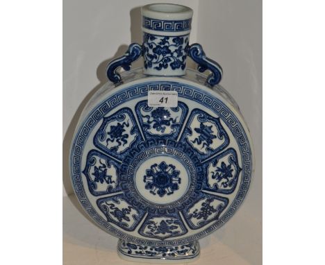 A Chinese blue and white moon flask, decorated with lotus leaf panels each with precious objects, S-scroll handles 36cm high
