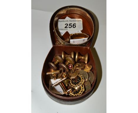 A 9ct gold chain link bracelet; 9ct gold toggle in the form of a buckled belt; a 9ct rolled gold bangle; enamelled cufflinks,