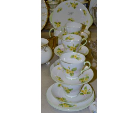 A Shelley Primrose pattern tea service, for six, printed with primroses, green line borders and handles, printed marks;  a Sh