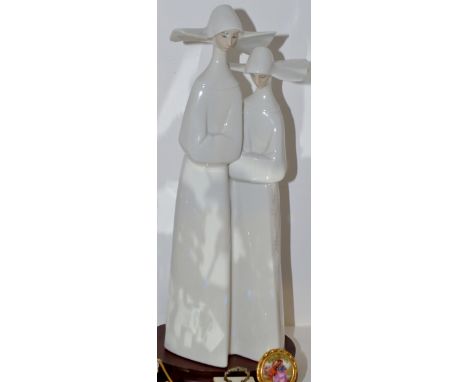 A Lladro figure, Pair of Nuns, mahogany base