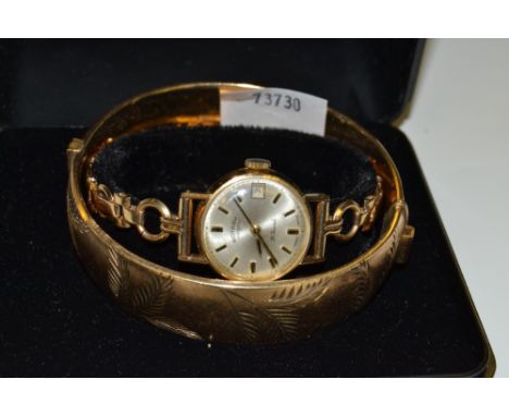 A ladies Rotary 9ct gold wrist watch with fancy 9ct gold strap;  a rolled gold hinged bangle (2)