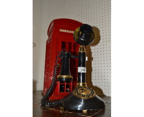 A novelty telephone holder, of a British red telephone box;  a Betacom replica stick telephone (2)