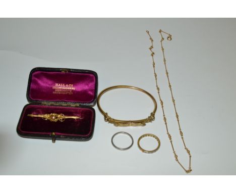 A 9ct gold brooch, 2g;  a platinum ring, 4.4g;  a gold plated bangle; a 9ct gold chain 