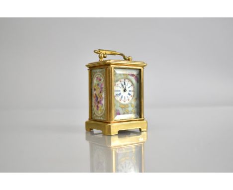 A Reproduction Miniature Gilt and Porcelain Panel Carriage Clock in the Sevres Style with Key and Working Order, 7cm High whe