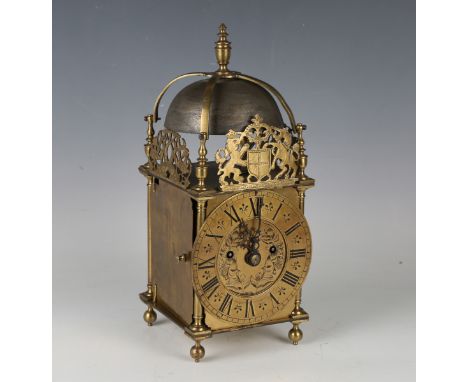 An early 20th century brass lantern clock with eight day twin fusee movement striking hours on a bell, the chapter ring with 