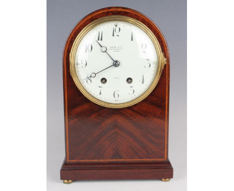 A late Victorian mahogany dome top mantel clock with French eight day movement striking on a gong, the circular enamelled con