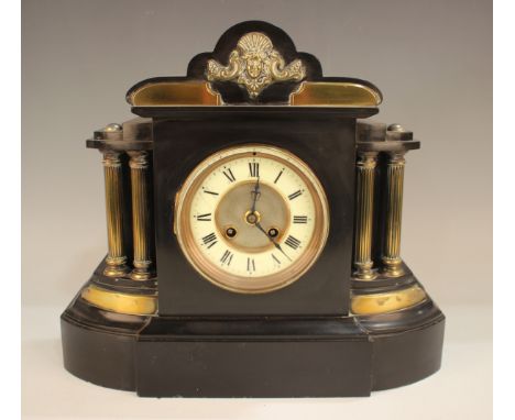 A late Victorian slate mantel clock with eight day movement striking on a gong, the enamelled chapter ring with black Roman h