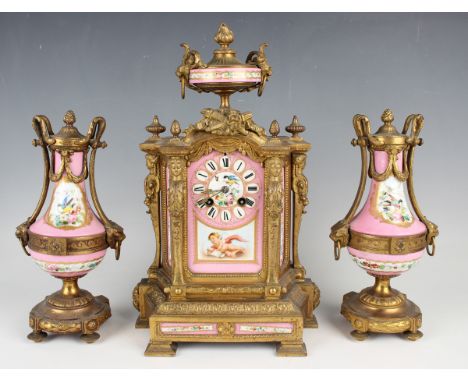 A late 19th century French gilt metal and porcelain clock garniture, the mantel clock with eight day movement striking on a b