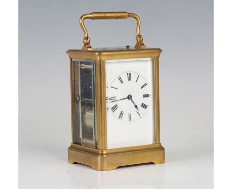 A late 19th century French gilt brass carriage clock with eight day movement striking hours, half hours and repeating on a go