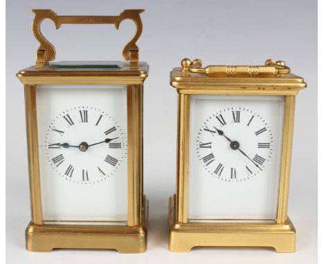 Two early 20th century French gilt brass carriage timepieces, each enamelled dial with black Roman hour numerals, each cornic