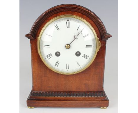An Edwardian mahogany mantel clock with French eight day movement striking on a gong, the circular white enamelled dial with 