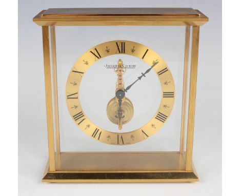 A Jaeger-LeCoultre gilt brass mantel timepiece, the brass chapter ring with black Roman hour numerals surrounding the signed 