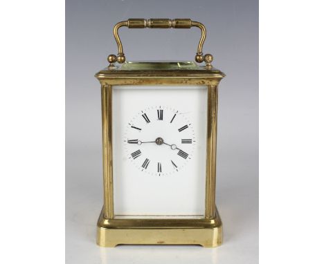 An early 20th century French brass cased carriage clock with eight day movement striking on a gong, the white enamelled dial 