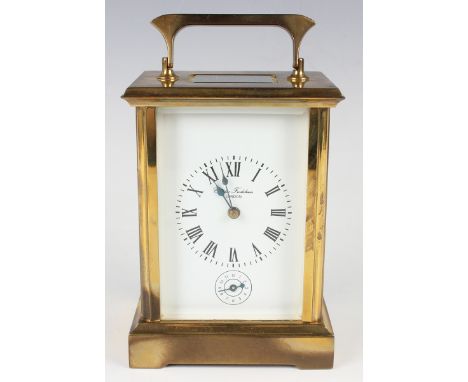 A 20th century French lacquered brass cased carriage alarm clock with eight day movement striking hours and alarm on a gong, 