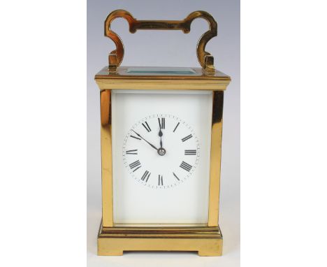 A 20th century French lacquered brass carriage clock with eight day movement striking hours and half hours on a gong, the whi