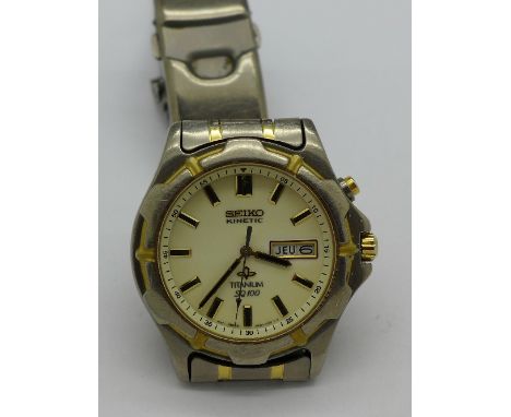 A Seiko Kinetic Titanium day date wristwatch with spare links