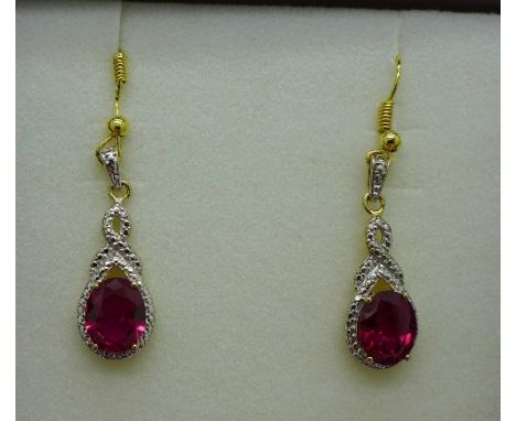 A pair of silver gilt earrings set with ruby simulants