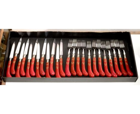 A SET OF TWELVE ROYAL WORCESTER PORCELAIN PISTOL HAFTED EPNS DESSERT KNIVES AND FORKS, DECORATED WITH PENDULOUS GILT FOLIAGE 