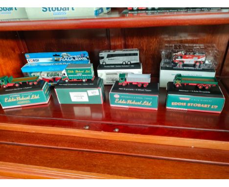 Shelf of boxed Eddie stobart model trucks etc 