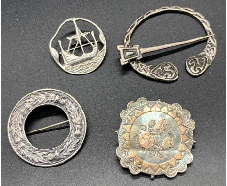 Four various silver brooches. Includes Celtic plaid brooch, Edinburgh silver long boat brooch by Tony Holland, Edinburgh silv