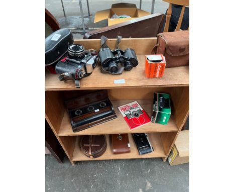 Selection of camera items to include Praktica camera, Binoculars, kodak bellow camera and ink well pot. 