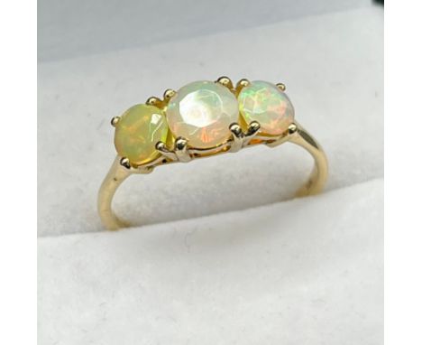 10ct yellow gold ladies ring set with three opalescent style stones. [Ring size R] [1.91Grams] 