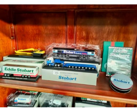 Shelf of boxed Eddie stobart model trucks etc 