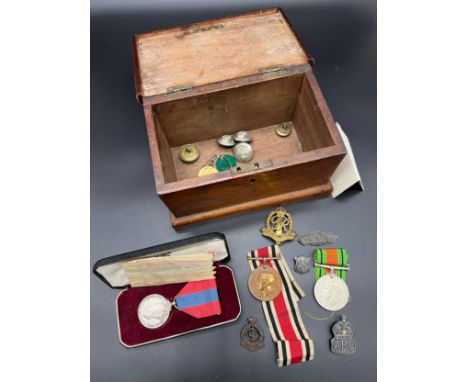 Small Mahogany/ dark wood chest containing a quantity of military items. Includes WW2 Defence medal, Constabulary medal, Impe