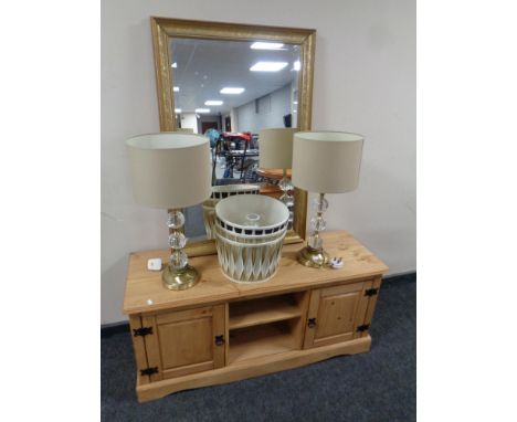 A contemporary pine entertainment stand together with a gilt framed mirror, pair of table lamps with shades and three further