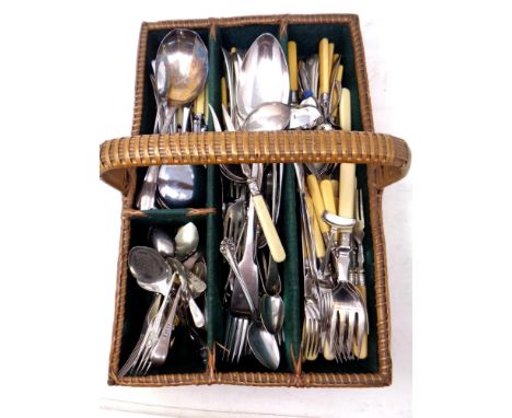 A vintage wicker cutlery basket containing a quantity of silver plated cutlery 