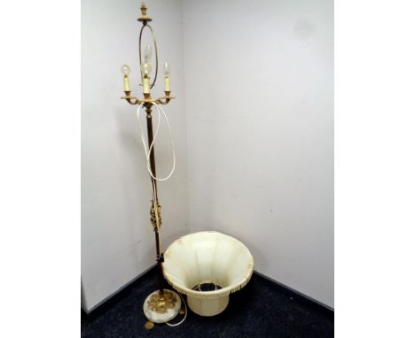 A 20th century brass and alabaster standard lamp on paw feet with shade 
