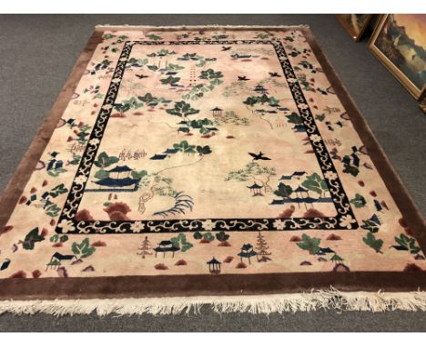 A Chinese style carpet on pink ground, 250cm x 330cm