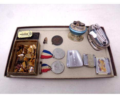 A tray of commemorative medals, vintage lighters etc 