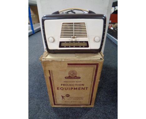 A mid century bakelite cased radio together with a Bell and Howell projector in original box