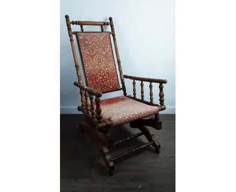 VICTORIAN ROCKING CHAIR, with upholstered back and seat and on bobbin turned supports