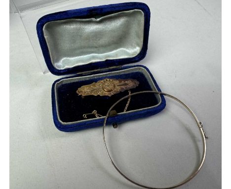 VICTORIAN BAR BROOCH, AND A BANGLE the brooch in fifteen carat gold, the bangle in nine carat gold Qty: brooch 2.7g, bangle 1