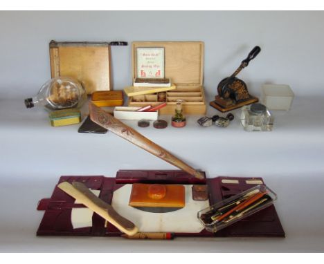 A box of mixed miscellaneous desk top items to include silver topped ink wells, an ink well, ship in a bottle, blotters, stam