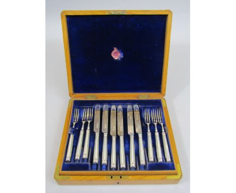 Attractive oak cased two tier canteen of mother of pearl and silver cutlery, comprising twelve knives and twelve forks, maker