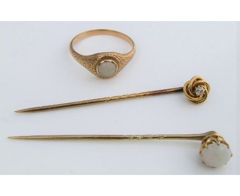 Two opal set items comprising a 15ct classical style engraved ring, size O/P and a 14ct claw set stick pin, together with a f