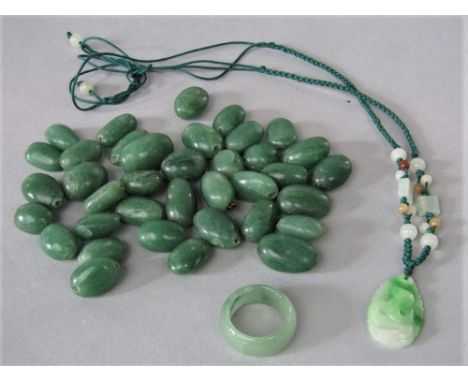 A quantity of spinach jade beads together with a jade type ring and necklace