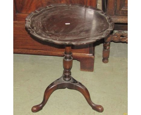 A good quality Georgian style occasional table, the circular pie-crust top raised on a  vase shaped pillar and tripod