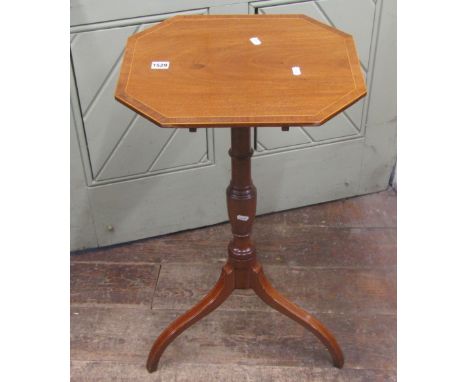 A small Georgian mahogany occasional table, the elongated octagonal top raised on a vase shaped pillar and tripod, with strin