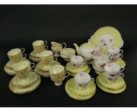 A collection of Paragon china tea wares in the Art Deco manner with yellow floral decoration comprising milk jug, sugar bowl,