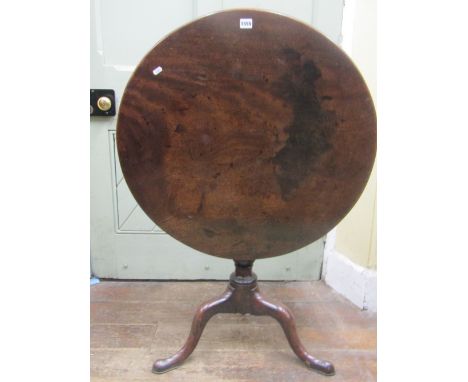 A Georgian mahogany snaptop table, the circular one piece top 75cm diameter, raised on a vase shaped pillar, with well shaped