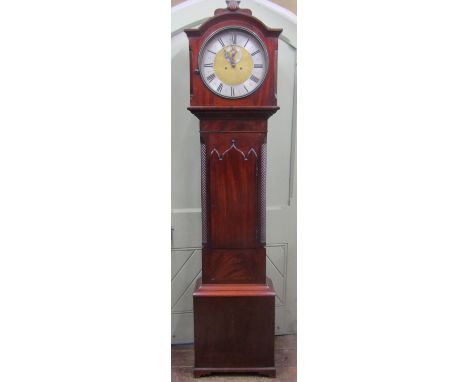 A Regency mahogany longcase clock, the door with lancet shaped outline, enclosing a circular dial with silvered chapter ring,