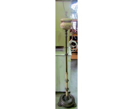 A Victorian brass and ceramic telescopic oil lamp standard with disc shaped base and cast foliate feet (later converted to el