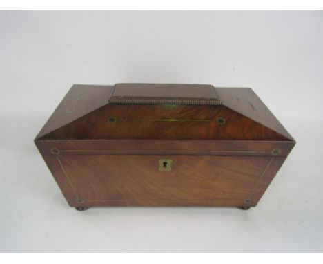 19th century flame mahogany and brass inlaid sarcophagus caddy, the hinged lid enclosing an interior fitted with a glass jar 